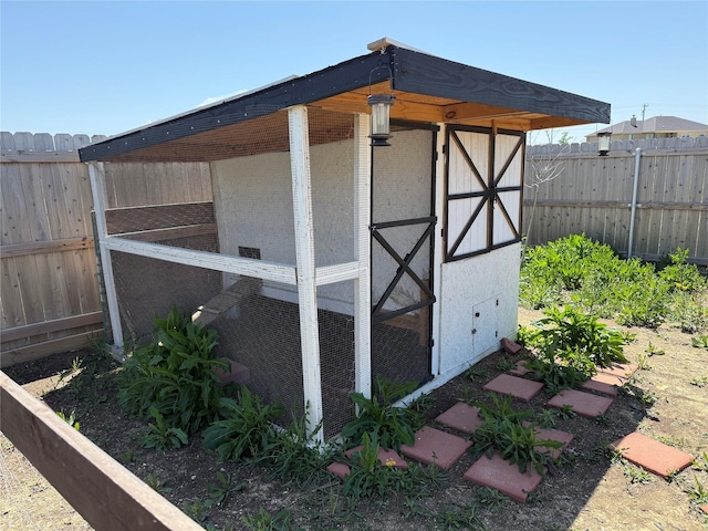 view of poultry coop with a fenced backyard