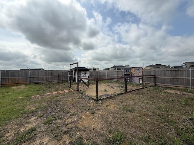 view of yard with exterior structure, an outbuilding, and a fenced backyard
