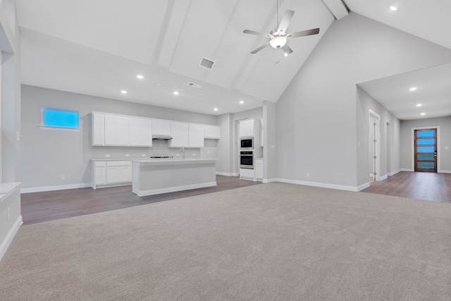 880 Brookwood Blvd, Haslet, TX 76052 - unfurnished living room with light carpet, high vaulted ceiling, a ceiling fan, baseboards, and recessed lighting
