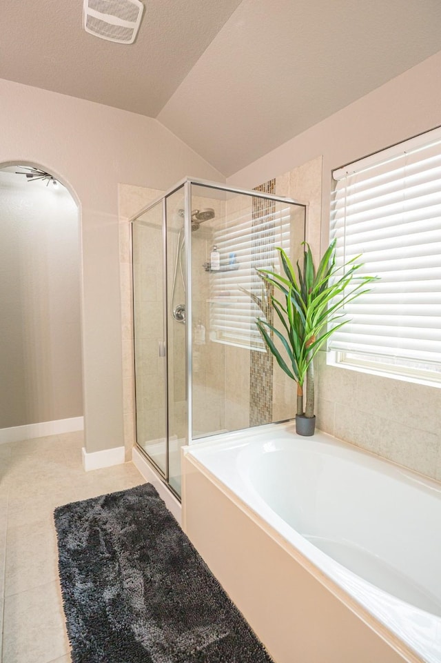 1025 N Churchill Dr, Fate, TX 75189 - bathroom with a shower stall, vaulted ceiling, a garden tub, and tile patterned floors