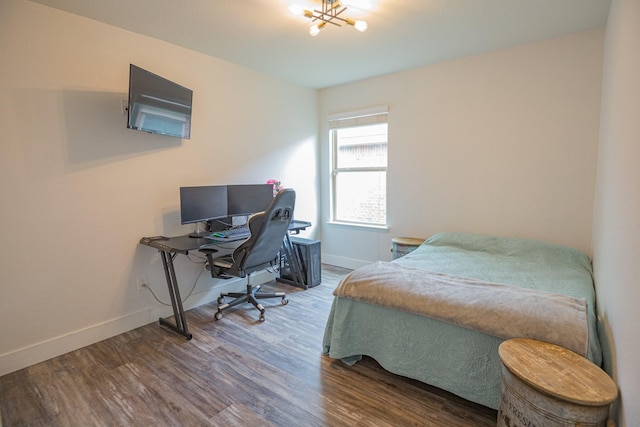 1025 N Churchill Dr, Fate, TX 75189 - bedroom with wood finished floors, baseboards, an office area, and a chandelier