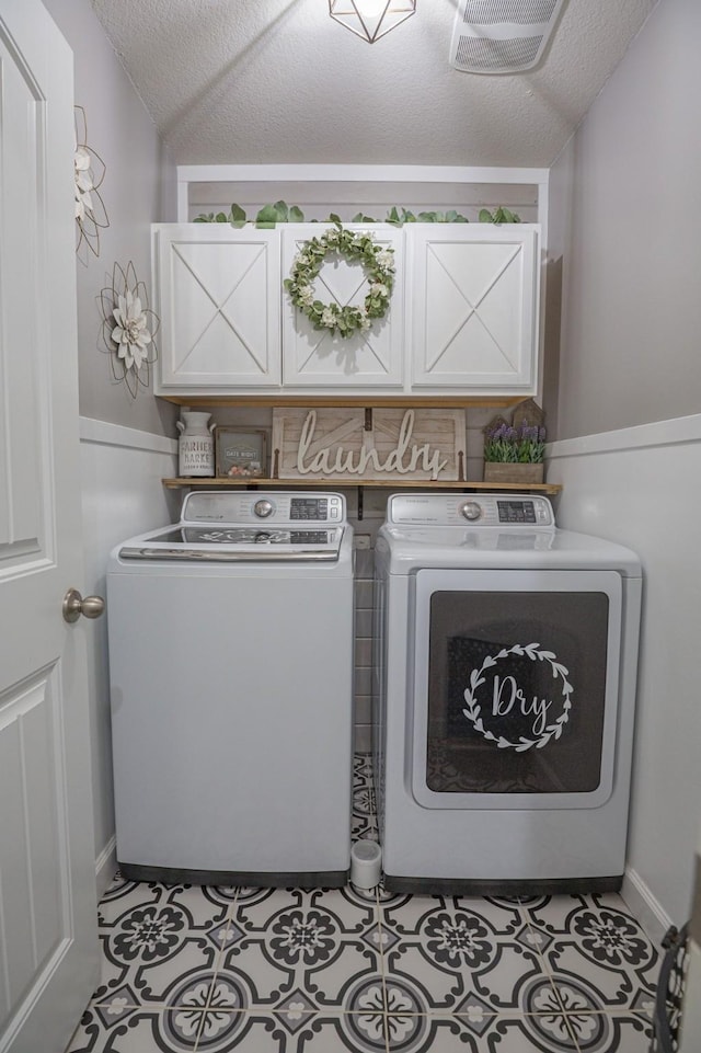 1025 N Churchill Dr, Fate, TX 75189 - laundry area featuring cabinet space, washing machine and clothes dryer, and a textured ceiling