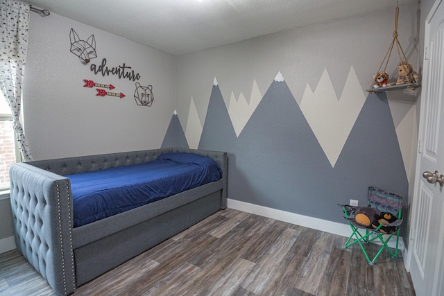 1025 N Churchill Dr, Fate, TX 75189 - bedroom featuring wood finished floors and baseboards