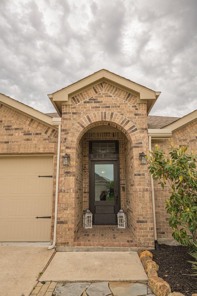 1025 N Churchill Dr, Fate, TX 75189 - doorway to property with brick siding and a garage