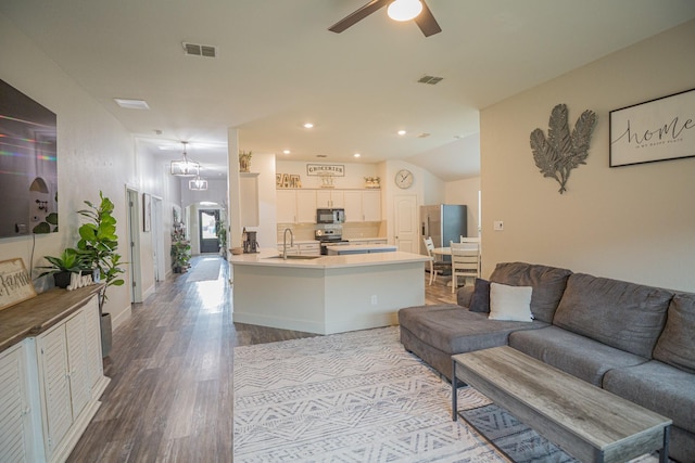 1025 N Churchill Dr, Fate, TX 75189 - living area with wood finished floors, ceiling fan, recessed lighting, and arched walkways