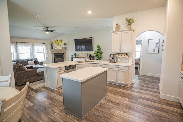 1025 N Churchill Dr, Fate, TX 75189 - kitchen with ceiling fan, a peninsula, arched walkways, light countertops, and open floor plan