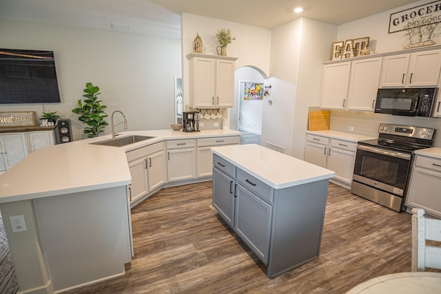 1025 N Churchill Dr, Fate, TX 75189 - kitchen featuring black microwave, stainless steel electric stove, a sink, gray cabinetry, and decorative backsplash