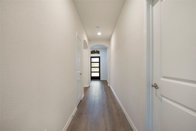 10337 Geode St, Aubrey, TX 76227 - hallway featuring dark wood-style flooring, baseboards, arched walkways, and recessed lighting