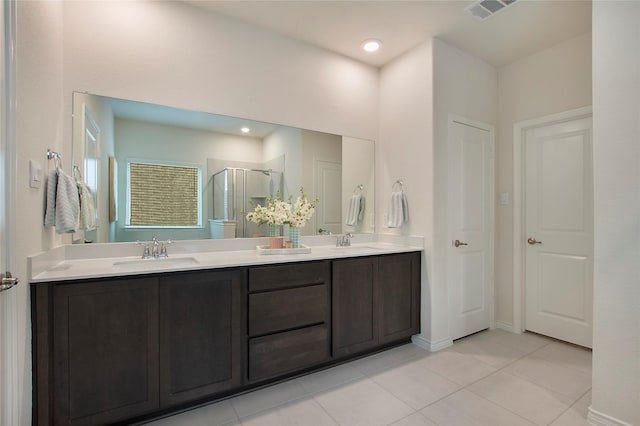 10337 Geode St, Aubrey, TX 76227 - full bathroom featuring a sink, visible vents, tile patterned flooring, a shower stall, and double vanity