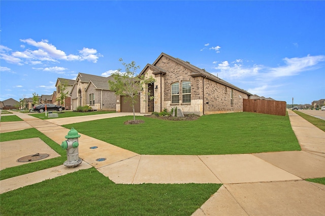 10337 Geode St, Aubrey, TX 76227 - view of front facade with an attached garage, a front lawn, brick siding, and driveway