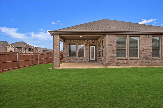 10337 Geode St, Aubrey, TX 76227 - back of house with a yard, brick siding, fence, a patio, and a shingled roof