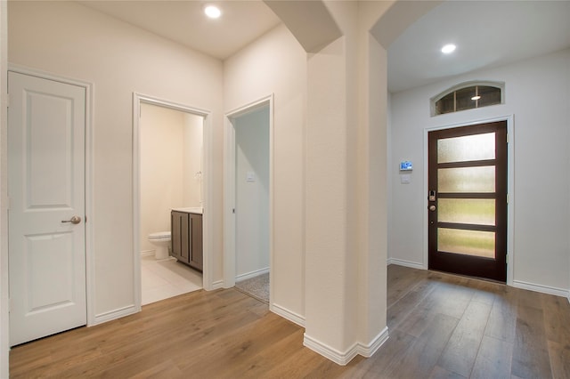 10337 Geode St, Aubrey, TX 76227 - entryway with light wood-style flooring, arched walkways, and baseboards