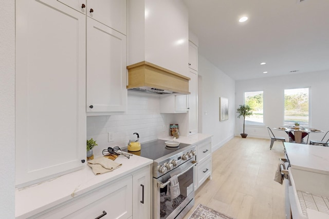3791 Evergreen Ln, Caddo Mills, TX 75135 - kitchen featuring white cabinetry, custom exhaust hood, backsplash, and high end stainless steel range