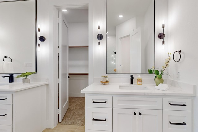 3791 Evergreen Ln, Caddo Mills, TX 75135 - full bathroom with a sink, a walk in closet, two vanities, a shower, and baseboards