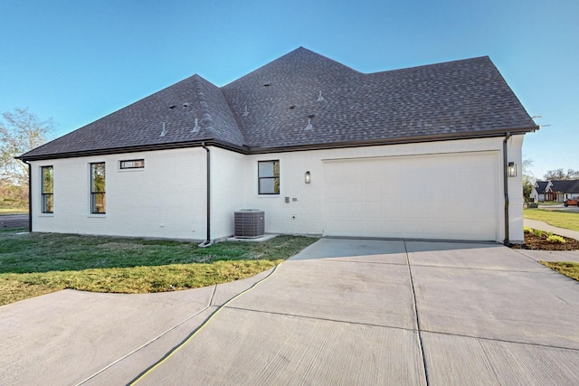 3791 Evergreen Ln, Caddo Mills, TX 75135 - exterior space featuring a lawn, driveway, a garage, central AC unit, and roof with shingles