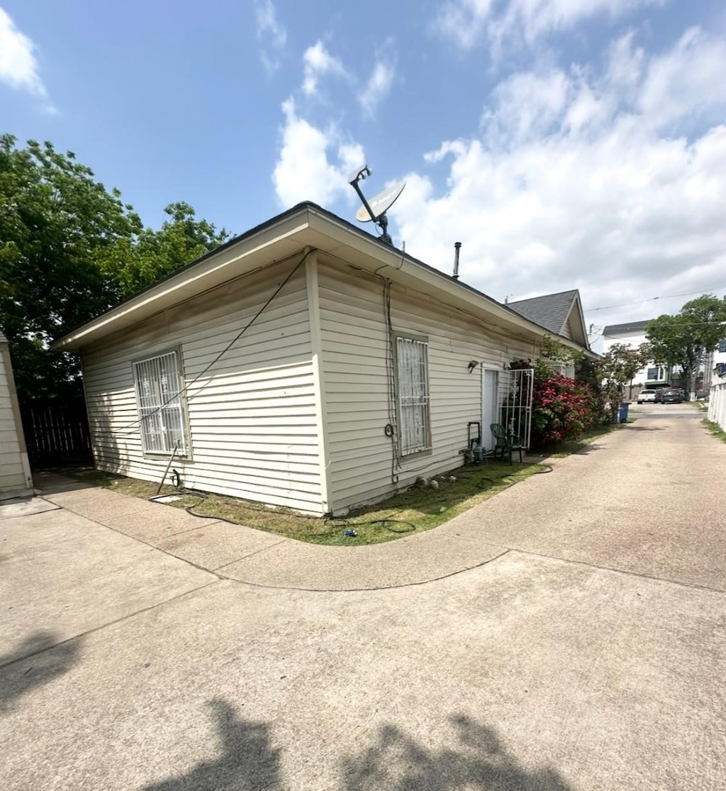view of home's exterior with fence and a patio