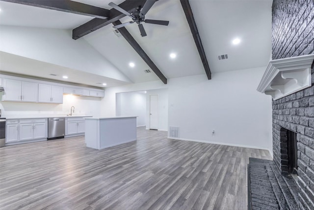 337 Travis Ln, Hewitt, TX 76643 - unfurnished living room with a ceiling fan, beam ceiling, a fireplace, light wood-type flooring, and visible vents