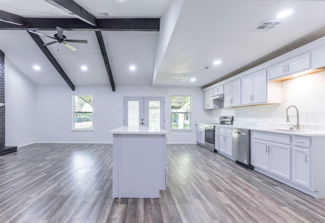 337 Travis Ln, Hewitt, TX 76643 - kitchen with a sink, stainless steel appliances, visible vents, light wood finished floors, and white cabinets