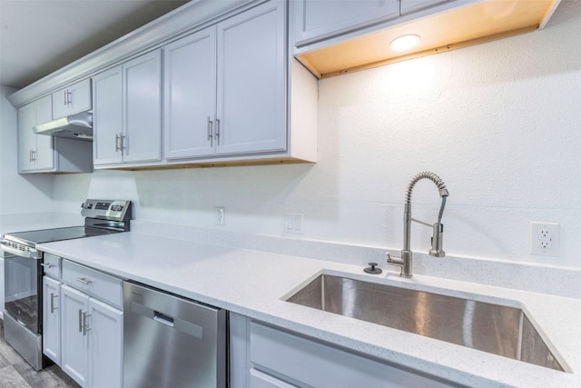 337 Travis Ln, Hewitt, TX 76643 - kitchen with under cabinet range hood, stainless steel appliances, light stone counters, and a sink