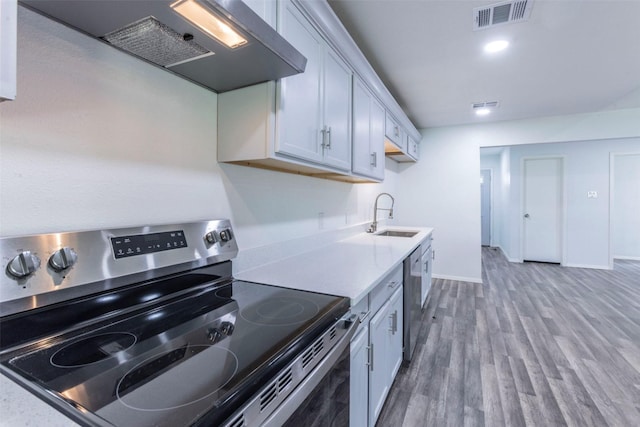 337 Travis Ln, Hewitt, TX 76643 - kitchen with custom exhaust hood, visible vents, a sink, light countertops, and appliances with stainless steel finishes