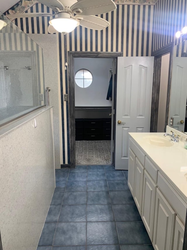 6001 Rock Cv, Flower Mound, TX 75028 - full bathroom with tile patterned floors, double vanity, a walk in shower, and wallpapered walls