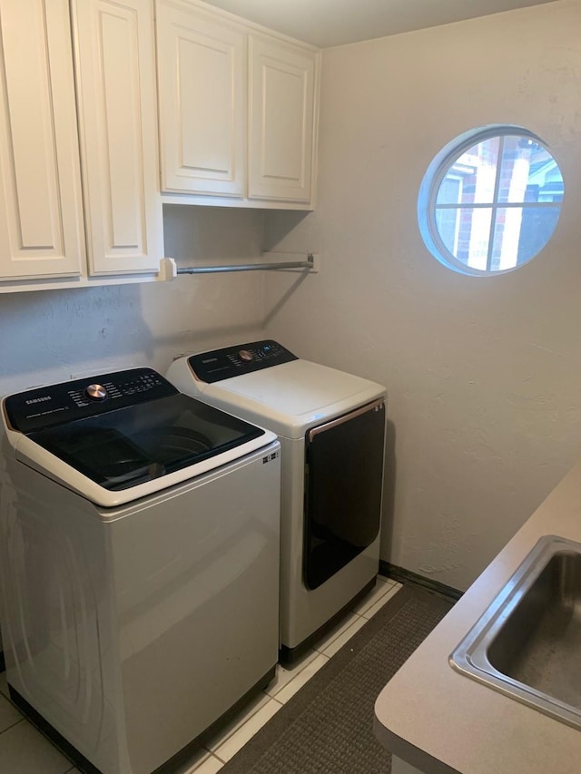 6001 Rock Cv, Flower Mound, TX 75028 - laundry area with cabinet space, washing machine and clothes dryer, and light tile patterned floors