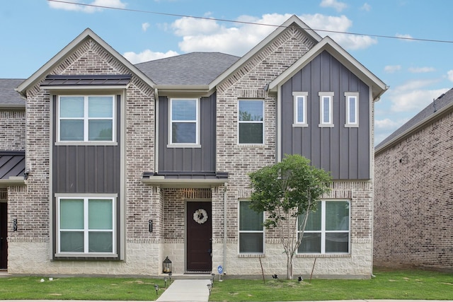 view of front facade featuring board and batten siding and brick siding