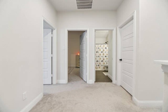 unfurnished bedroom with carpet flooring, ensuite bathroom, visible vents, and baseboards