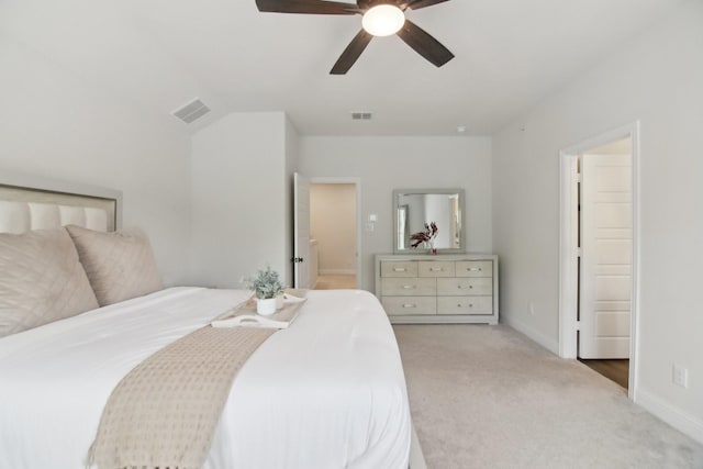 carpeted bedroom featuring baseboards, ceiling fan, and visible vents