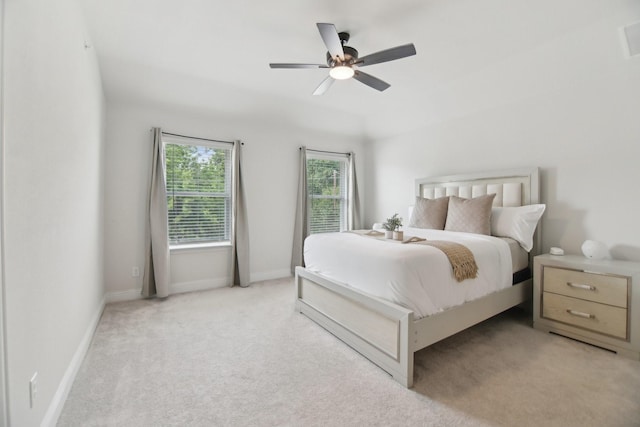 bedroom featuring baseboards, light carpet, and ceiling fan