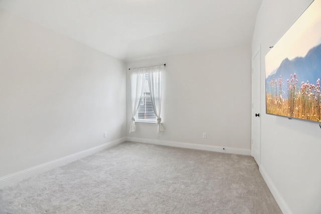 empty room featuring carpet and baseboards