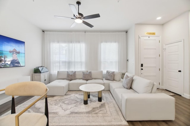 living room featuring wood finished floors and a ceiling fan