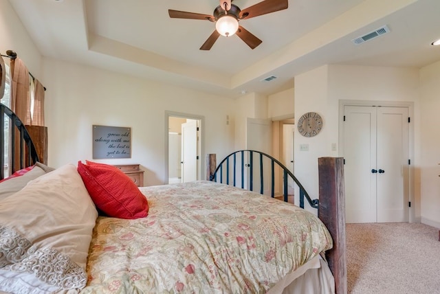 bedroom with ceiling fan, carpet flooring, a closet, and visible vents