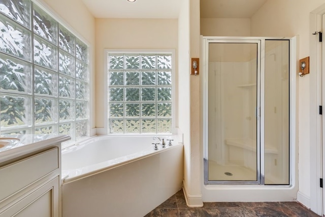 bathroom with a bath, vanity, and a shower stall