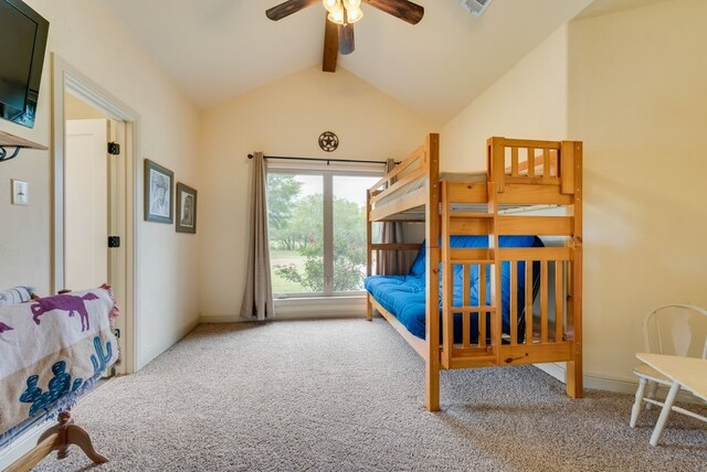 carpeted bedroom with visible vents, baseboards, and vaulted ceiling with beams