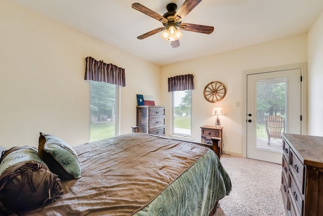bedroom featuring multiple windows, light carpet, access to outside, and ceiling fan