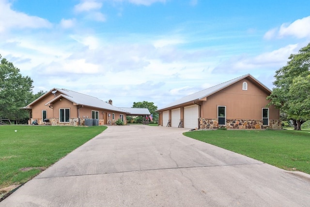 single story home with stone siding, central AC unit, driveway, and a front yard