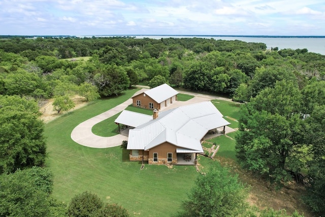 drone / aerial view featuring a water view and a view of trees