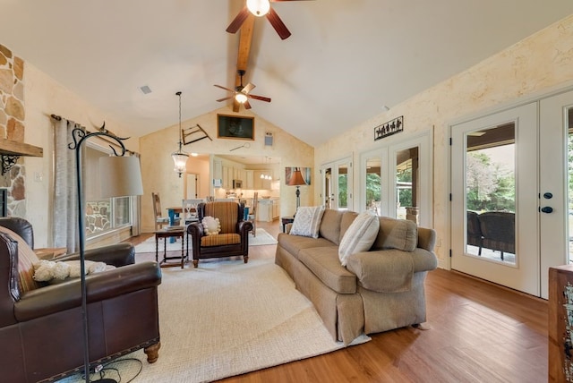 living area featuring french doors, wood finished floors, high vaulted ceiling, beamed ceiling, and a ceiling fan