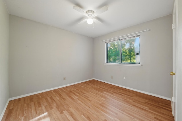 empty room with light wood-style floors, baseboards, and a ceiling fan