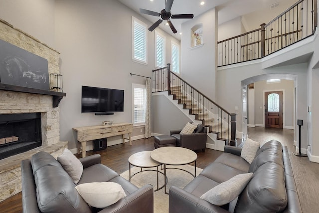 6404 Spring Wagon Dr, Mckinney, TX 75071 - living area with a towering ceiling, arched walkways, ceiling fan, wood finished floors, and baseboards