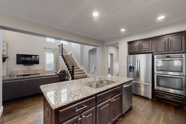 6404 Spring Wagon Dr, Mckinney, TX 75071 - kitchen with stainless steel appliances, a sink, dark wood-style flooring, dark brown cabinetry, and recessed lighting