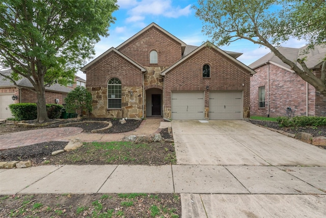 traditional-style house featuring stone siding, brick siding, and driveway