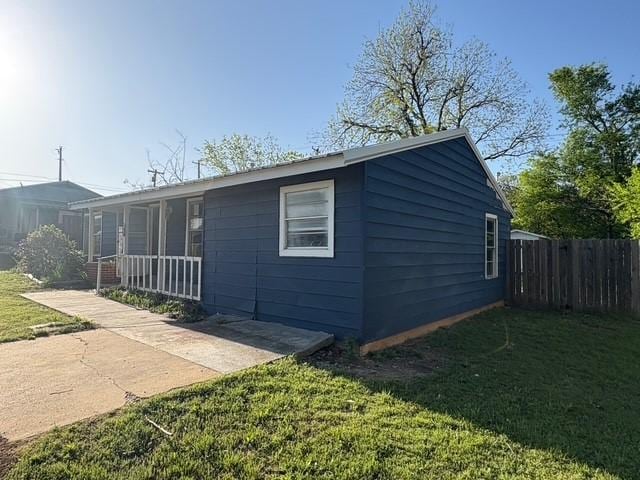 exterior space with a porch and fence