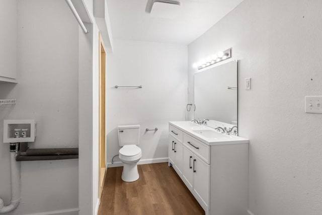 2349 Cooke St, Abilene, TX 79605 - bathroom with toilet, wood finished floors, and vanity