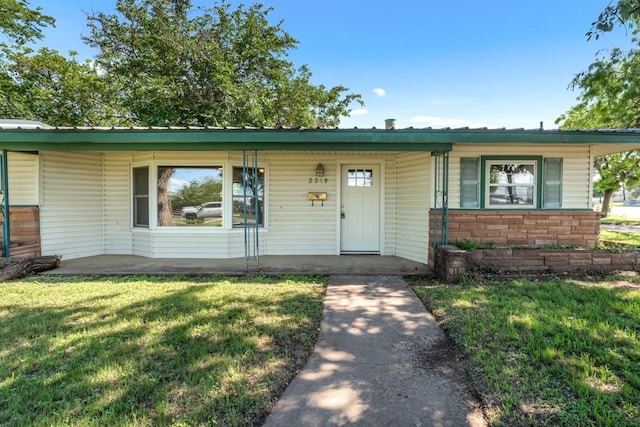 2349 Cooke St, Abilene, TX 79605 - view of front facade featuring a front yard, covered porch, and metal roof