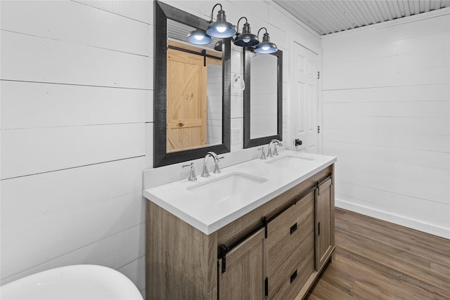2230 Farm Road 79, Paris, TX 75460 - bathroom with double vanity, wood finished floors, baseboards, and a sink