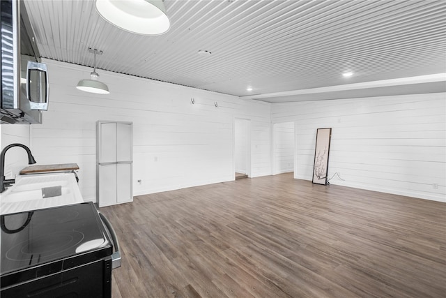 2230 Farm Road 79, Paris, TX 75460 - interior space with baseboards, a sink, open floor plan, black range with electric stovetop, and dark wood-type flooring