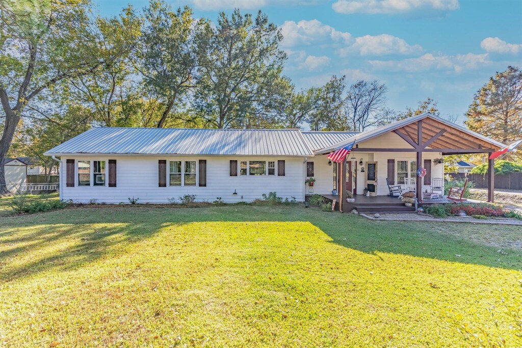 200 E Cedar, Winnsboro, TX 75494 - view of front of property with a porch, metal roof, and a front yard