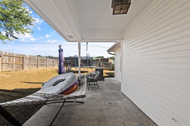 101 Remington Trl, Longview, TX 75604 - view of patio / terrace featuring a trampoline and a fenced backyard